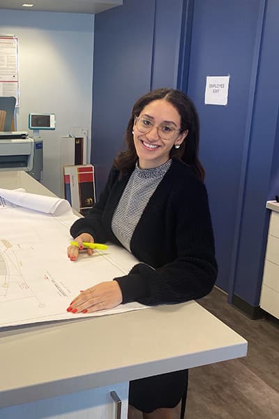 Architect reviewing marked drawings at a studio table