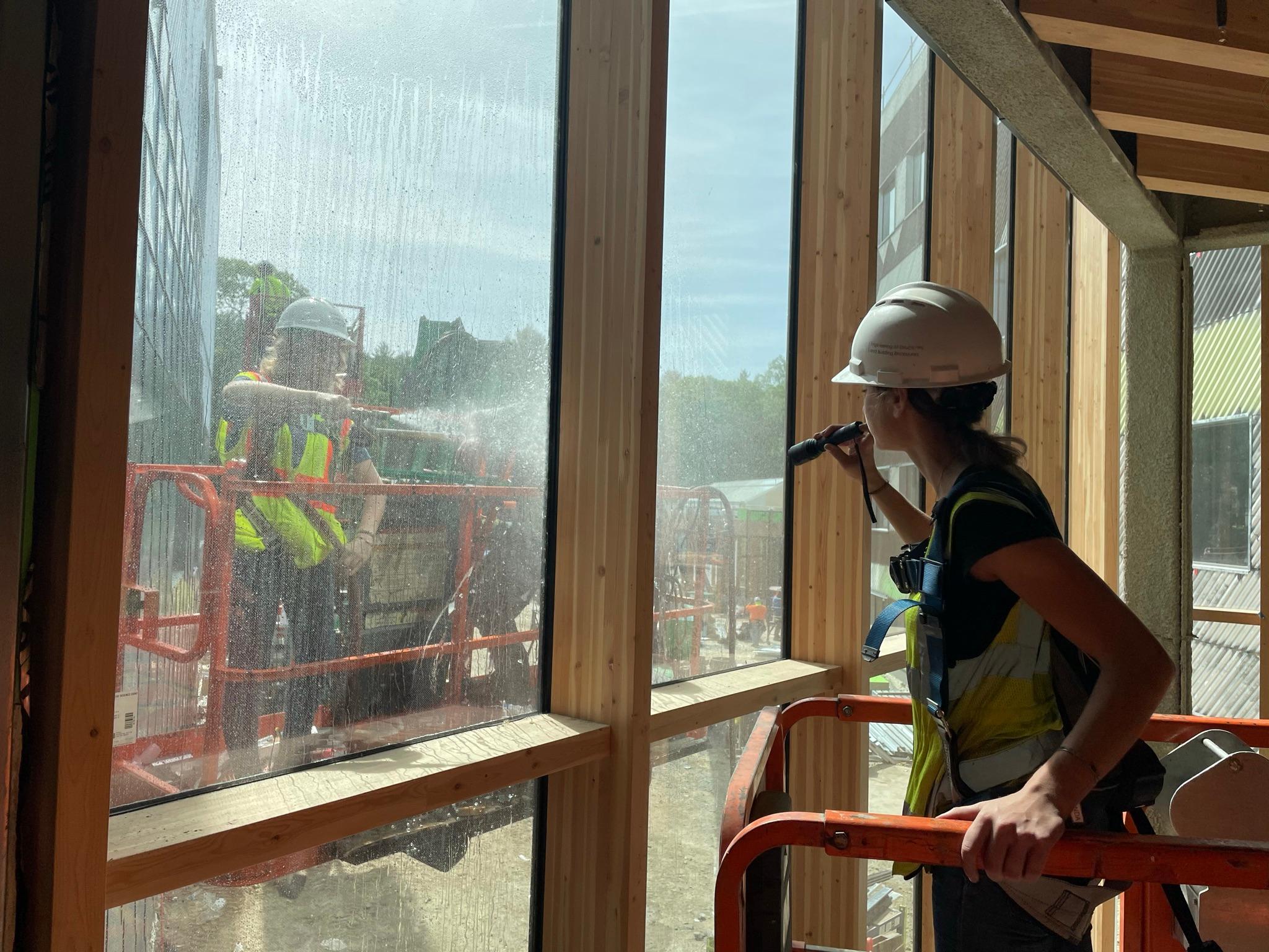 Specialist examining a large glazed opening in the field