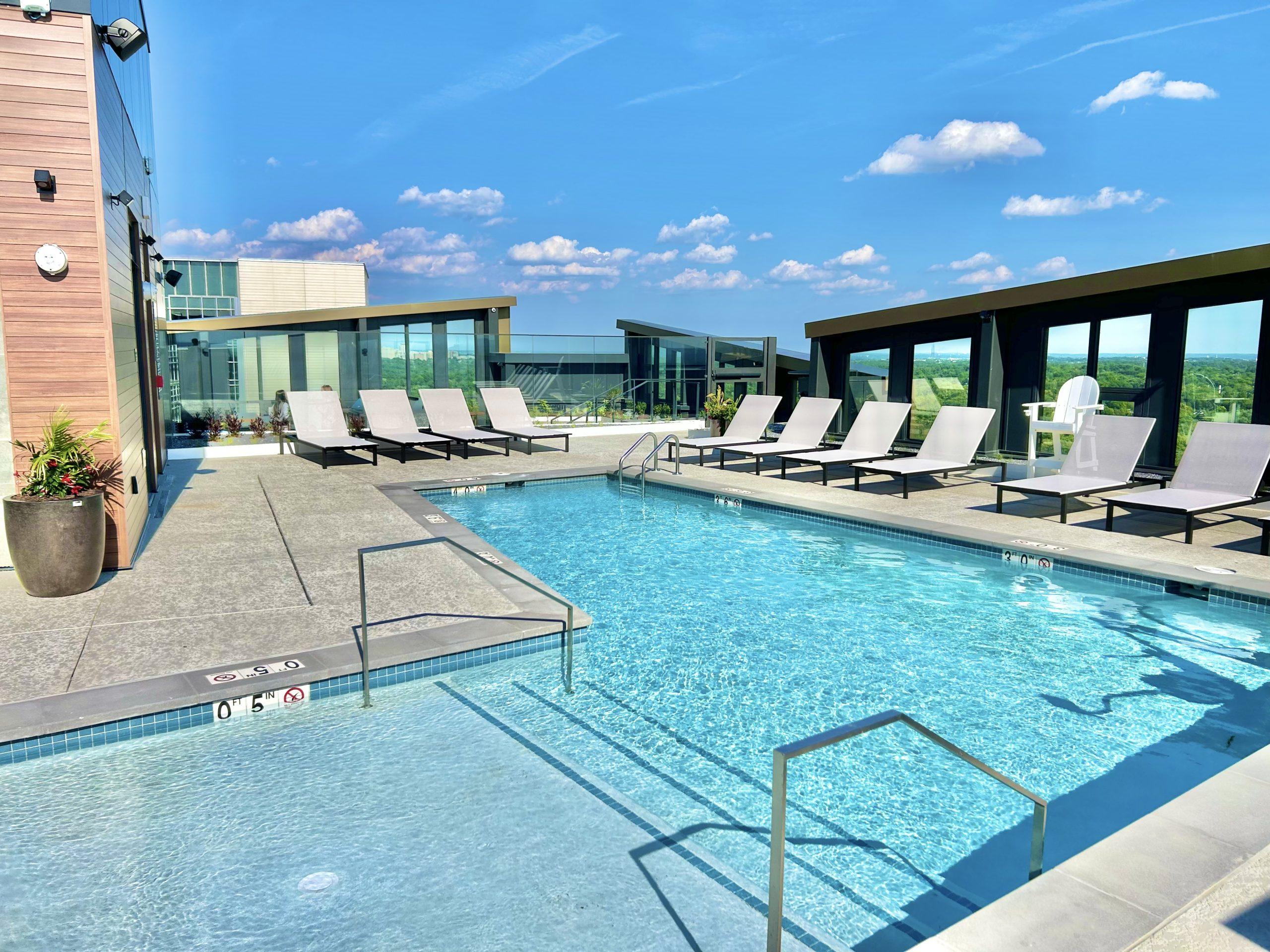 Rooftop pool terrace surrounded by the completed residential building