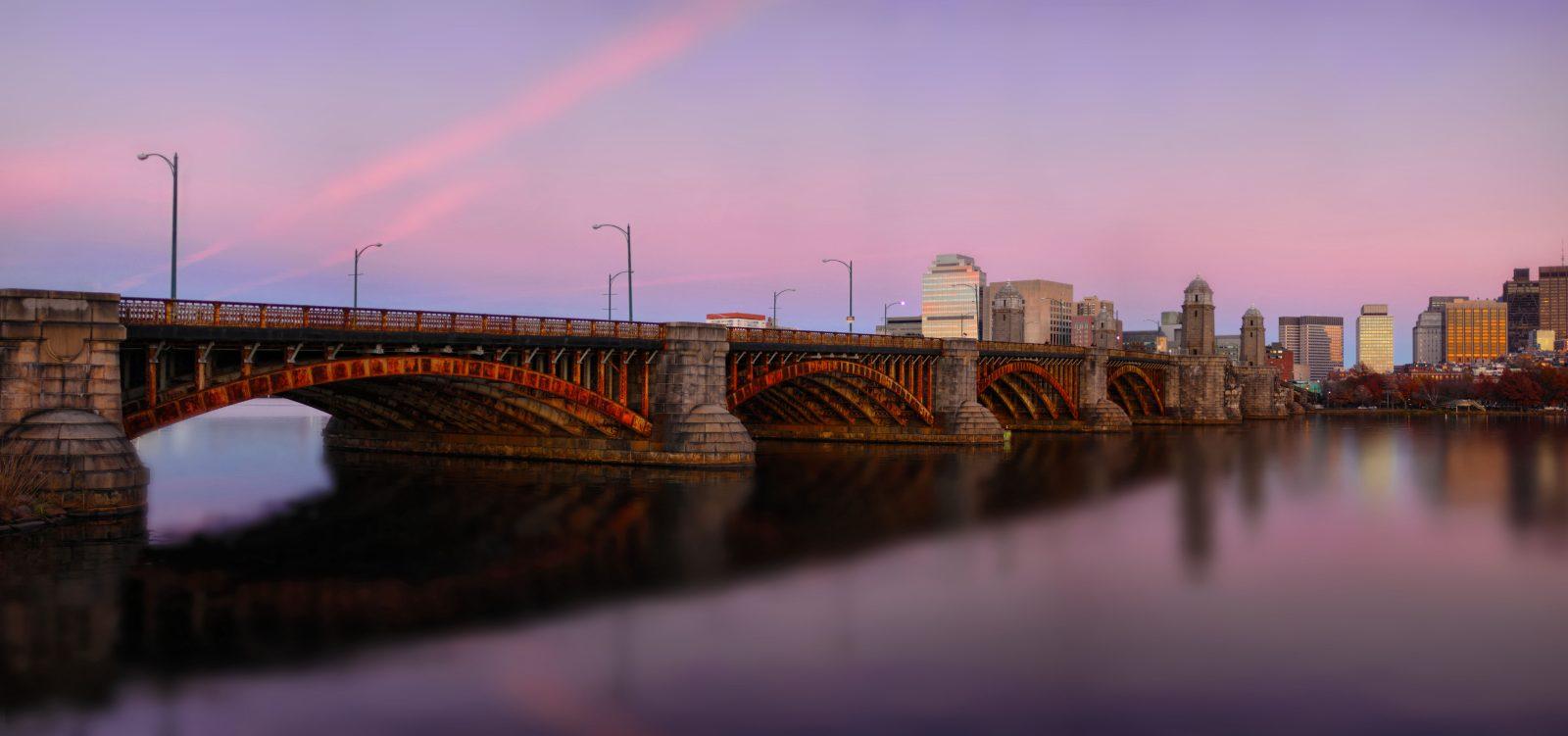 Long-span bridge crossing a river at dusk